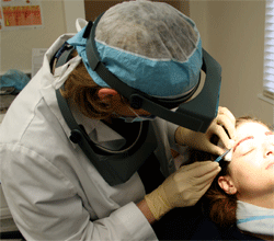 Dr. Wasserbauer inserts hair grafts into new eyebrows.